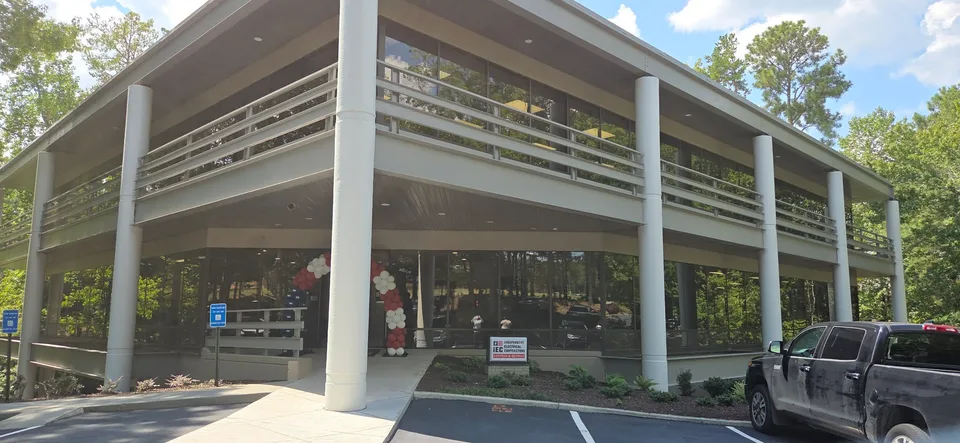 The IEC training center building with a red and white balloon arch at the entrance.